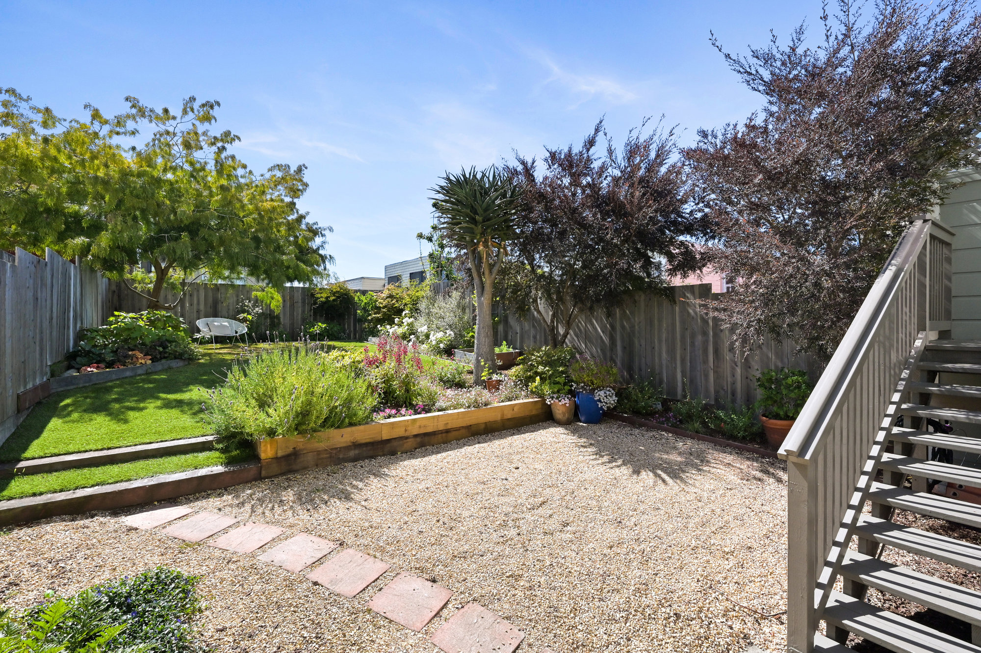 Property Photo: View of the large rear yard at 719 18th Avenue, showing various plants and trees