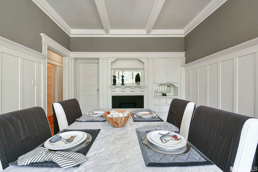Property Photo: View of another formal dining room, showing white boxed ceilings, wainscoting, and a fireplace