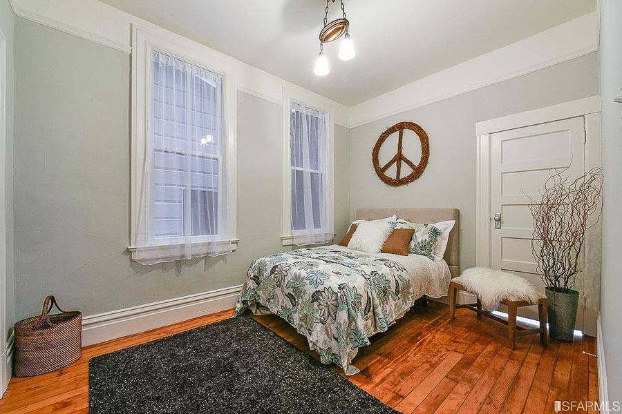 Property Photo: Another bedroom, featuring two large windows and wood floors