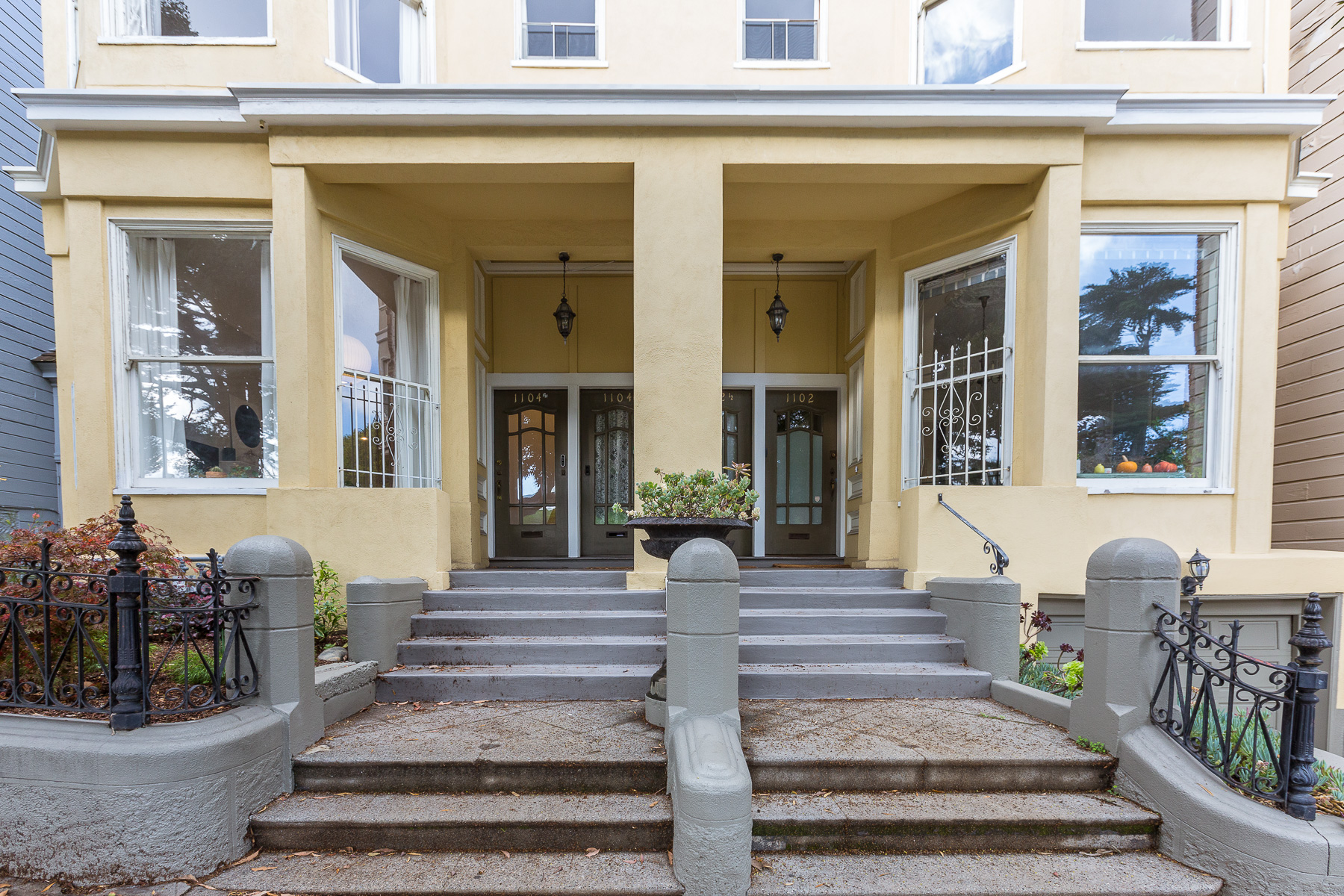 Property Photo: View of the front entry to 1104 Fulton, featuring a series of steps and four wood doors