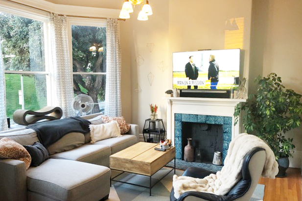 Property Photo: Living room with a large fireplace and bay windows