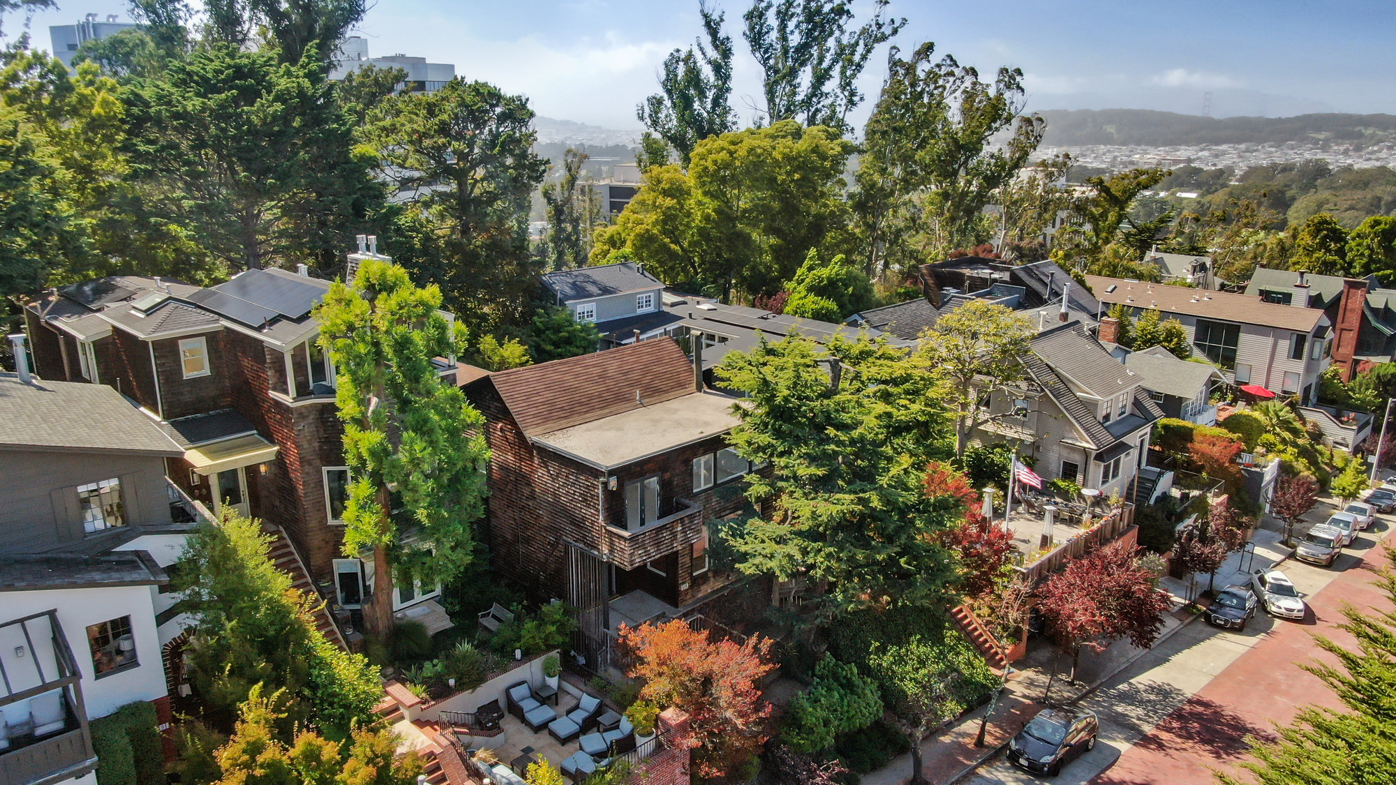 Property Photo: Aerial front view of 183 Edgewood Avenue, showing the home with the city beyond