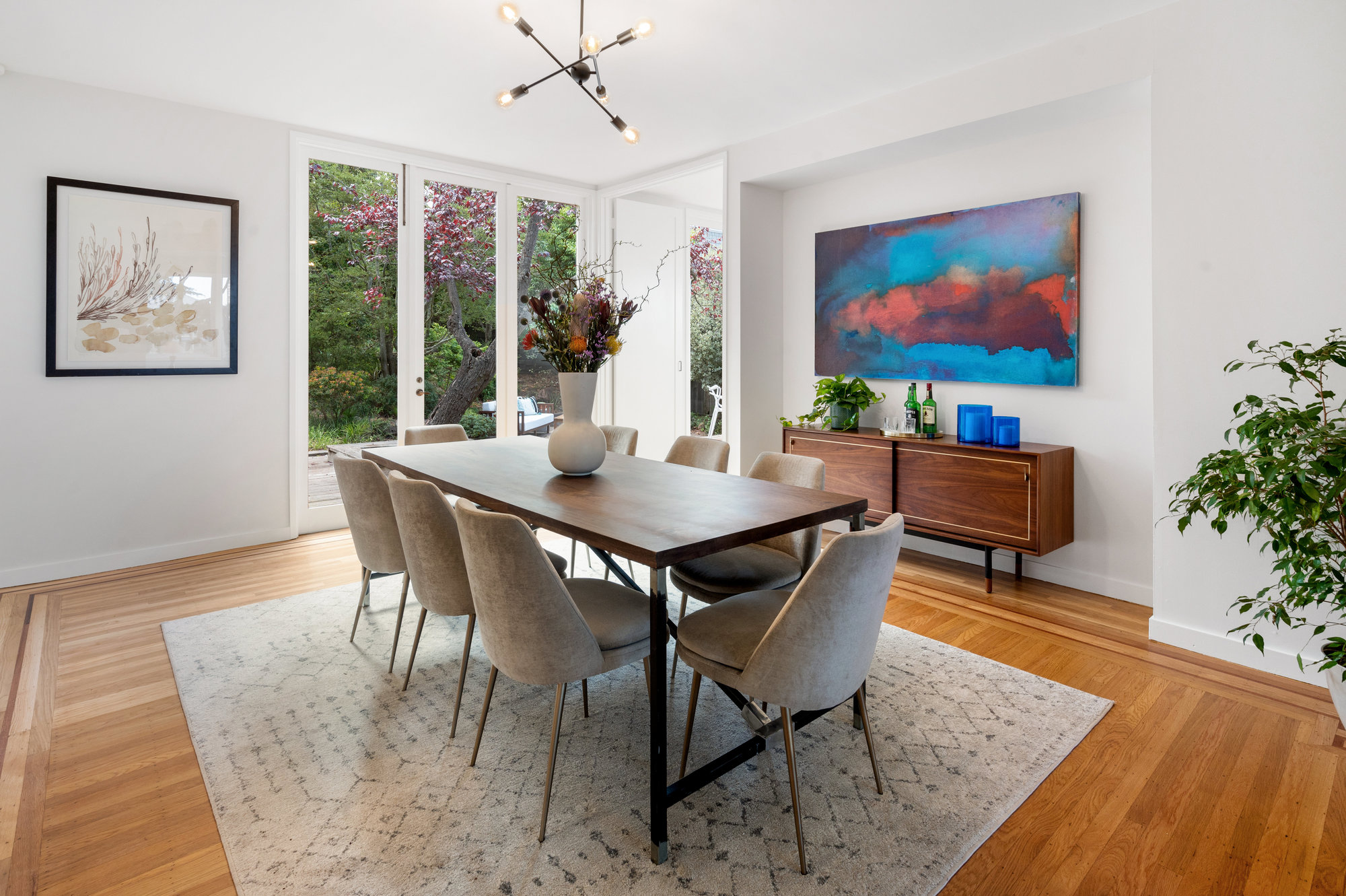 Property Photo: Dining room with wood floors and floor to ceiling windows