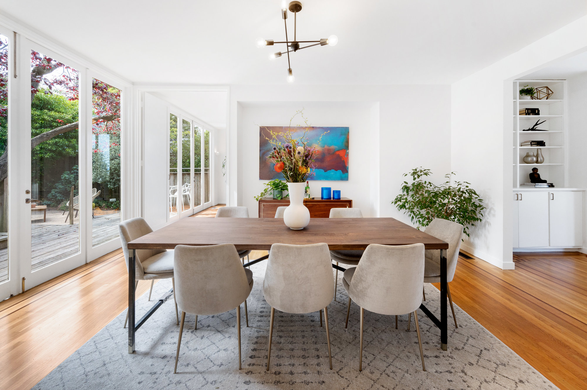 Property Photo: Formal dining room, with floor to ceiling windows and doors leading to the yard