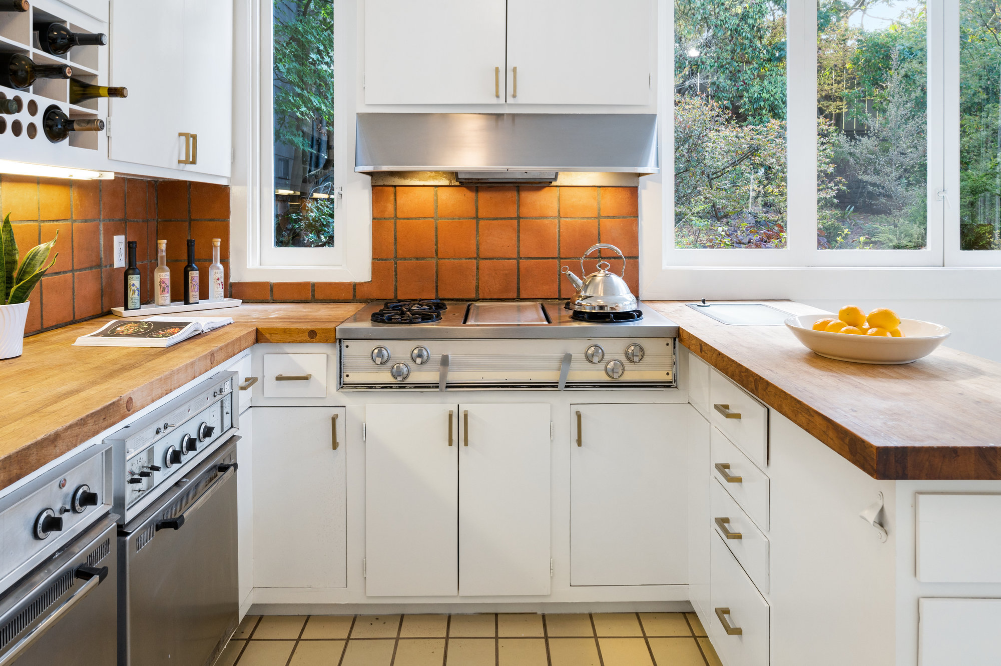 Property Photo: Kitchen showing terracotta tiled backsplash and plenty of natural light