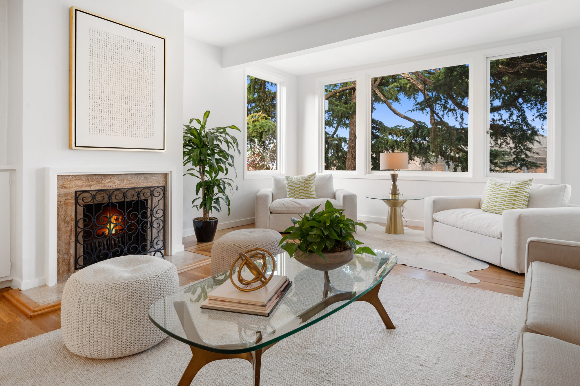 Property Photo: Close-up of the fireplace with wood surround, and wrap-around windows 