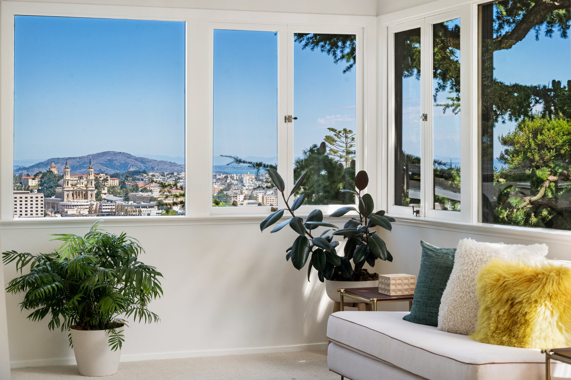 Property Photo: Close-up view of the corner windows in the primary suite, showing St Ignatius and the San Francisco skyline 