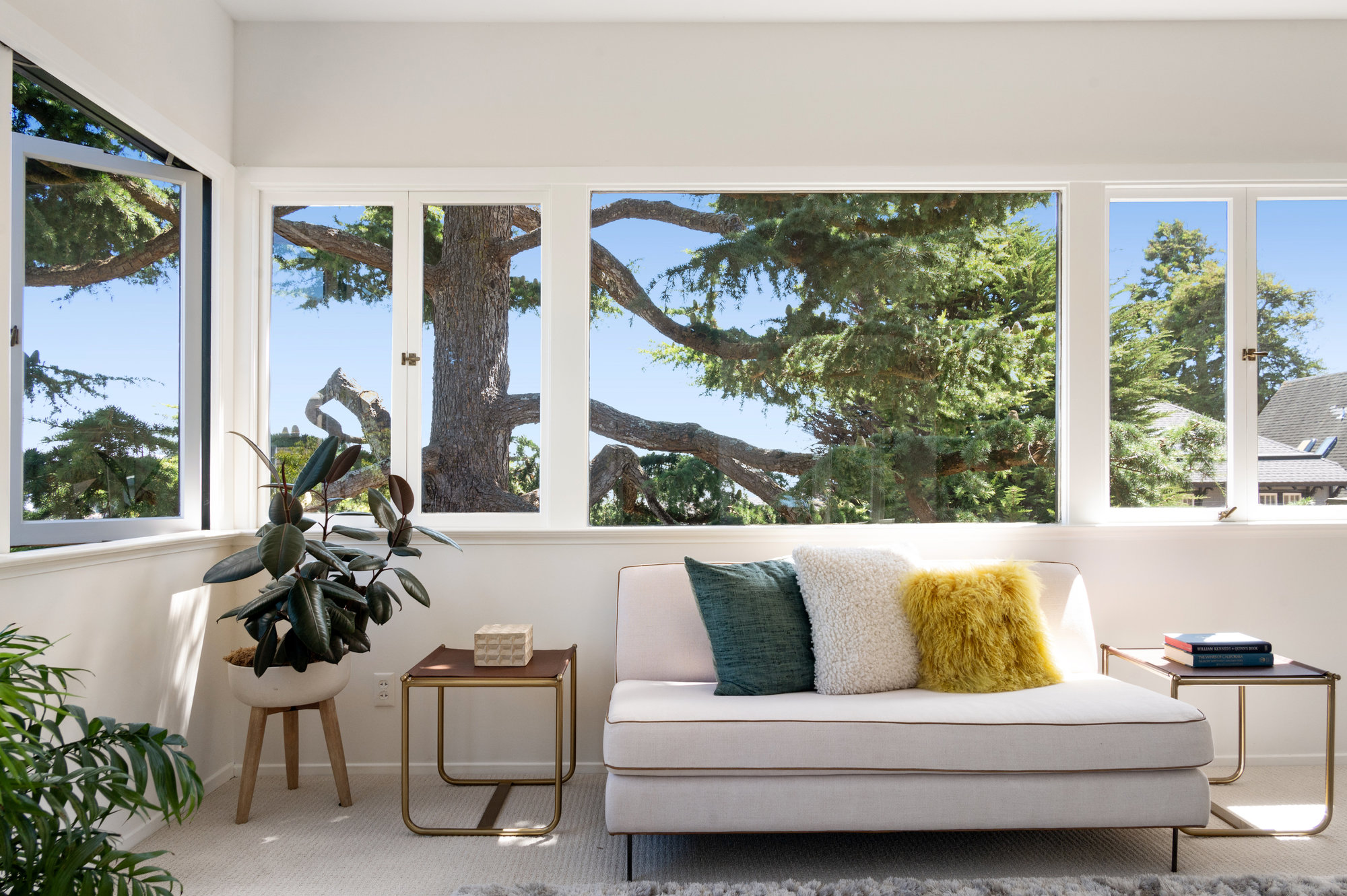 Property Photo: Tree-filled view of the sitting area with casement windows open