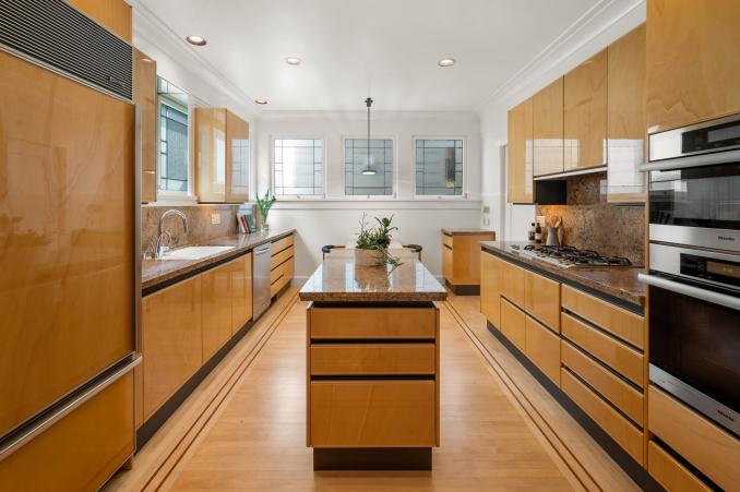 Property Thumbnail: View of the kitchen with sleek wood cabinets and floors