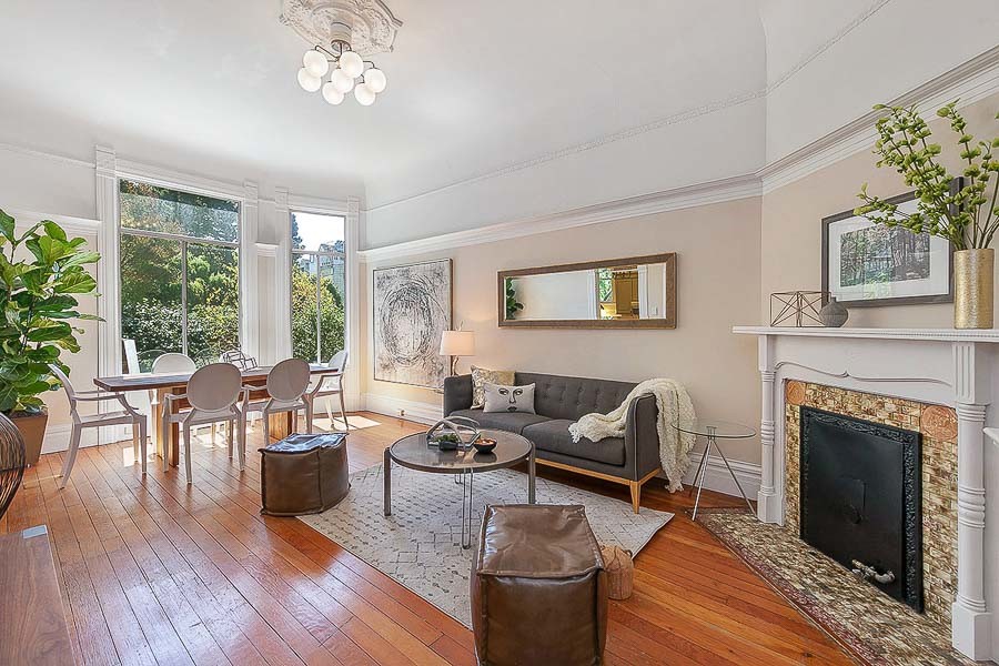 Property Photo: View of the living room, featuring wood floors and a fireplace