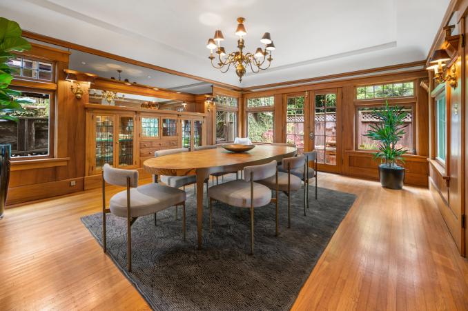 Property Thumbnail: Dining room with built-in wood shelves and exterior French glass doors 