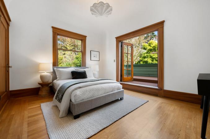Property Thumbnail: Second bedroom with wood floors and French doors opening to a private balcony