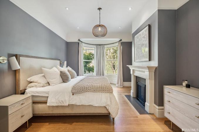 Property Thumbnail: Primary bedroom, featuring a bay window and wood floors