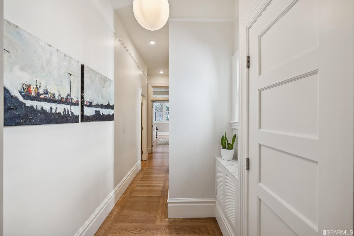 Property Photo: View of the hallway featuring wood floors, and a window nook ideal for plants