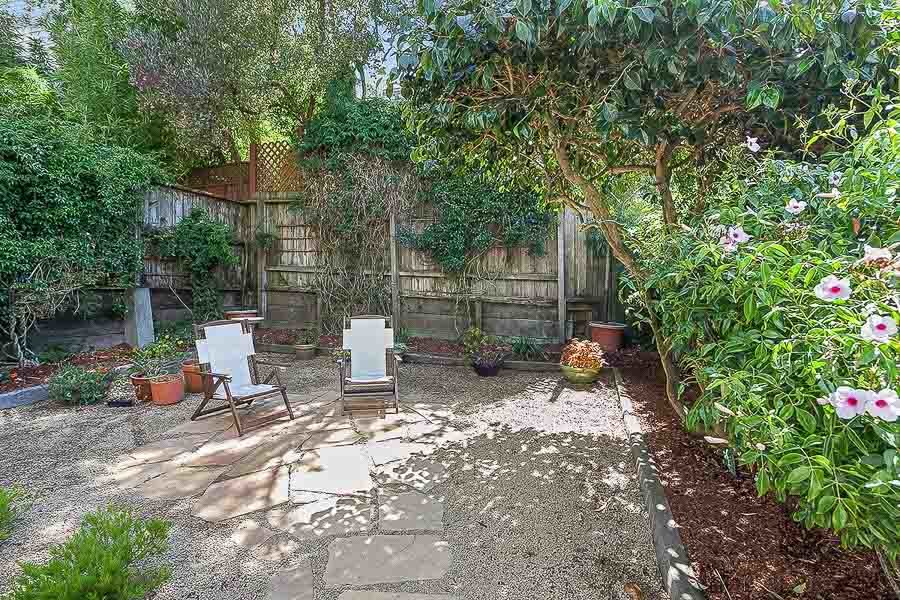 Property Photo: Exterior view of the out door living space, featuring flowering plants