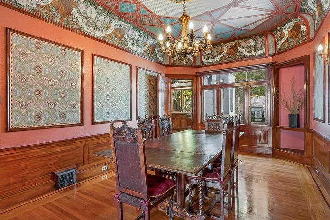 Property Thumbnail: View of the formal dining room, featuring wood floors, intricate woodwork, and a chandelier 