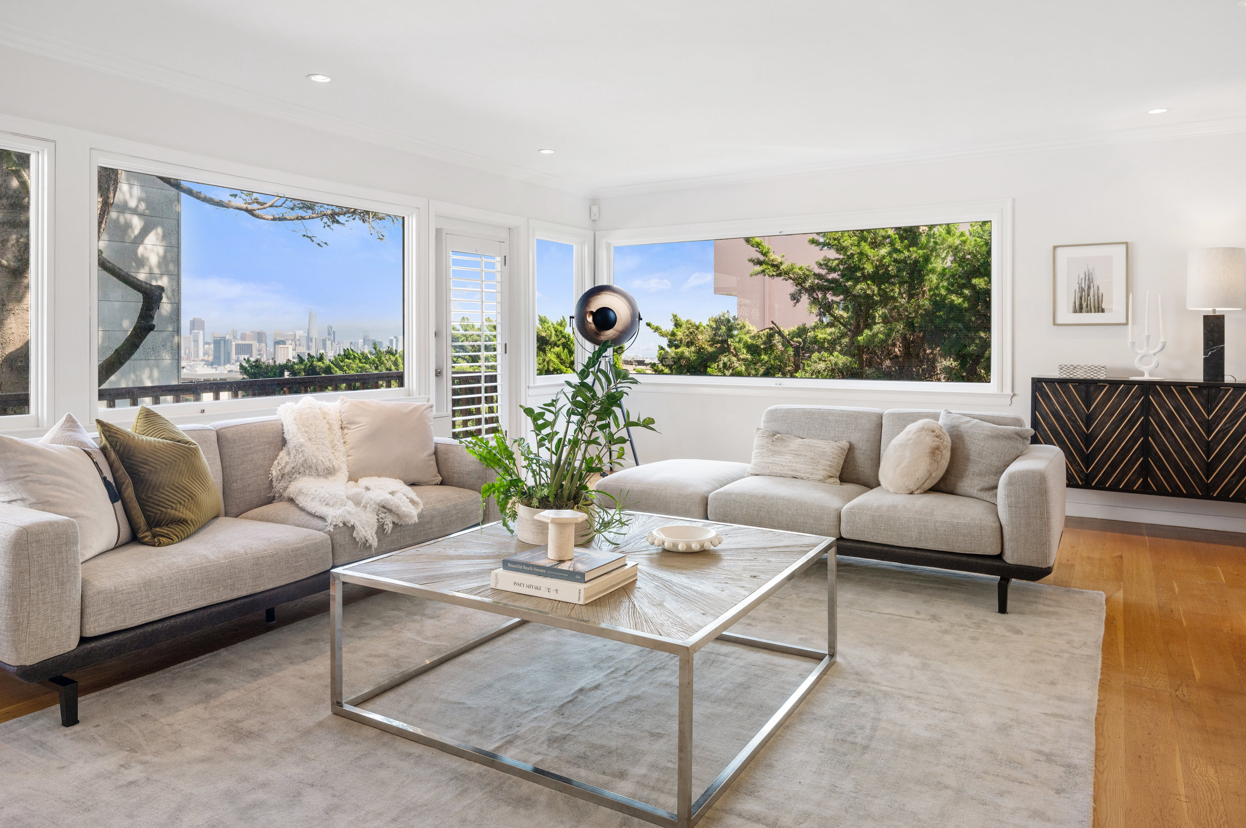 Property Photo: Living room with large windows and views of downtown San Francisco