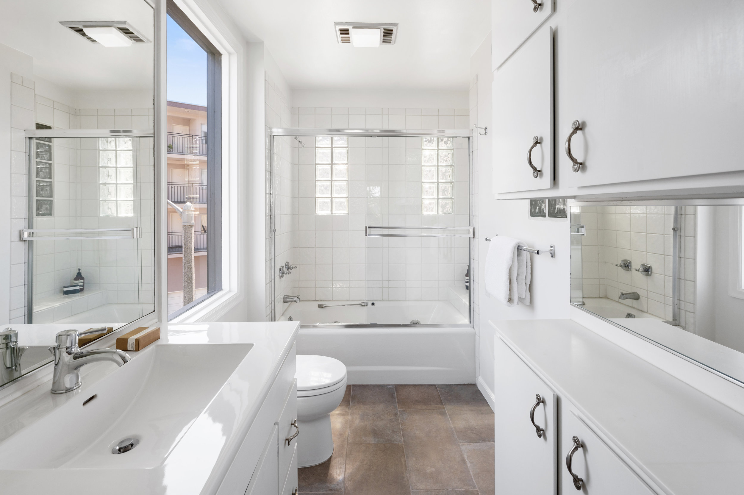 Property Photo: Ensuite bathroom with a large window and bath tub