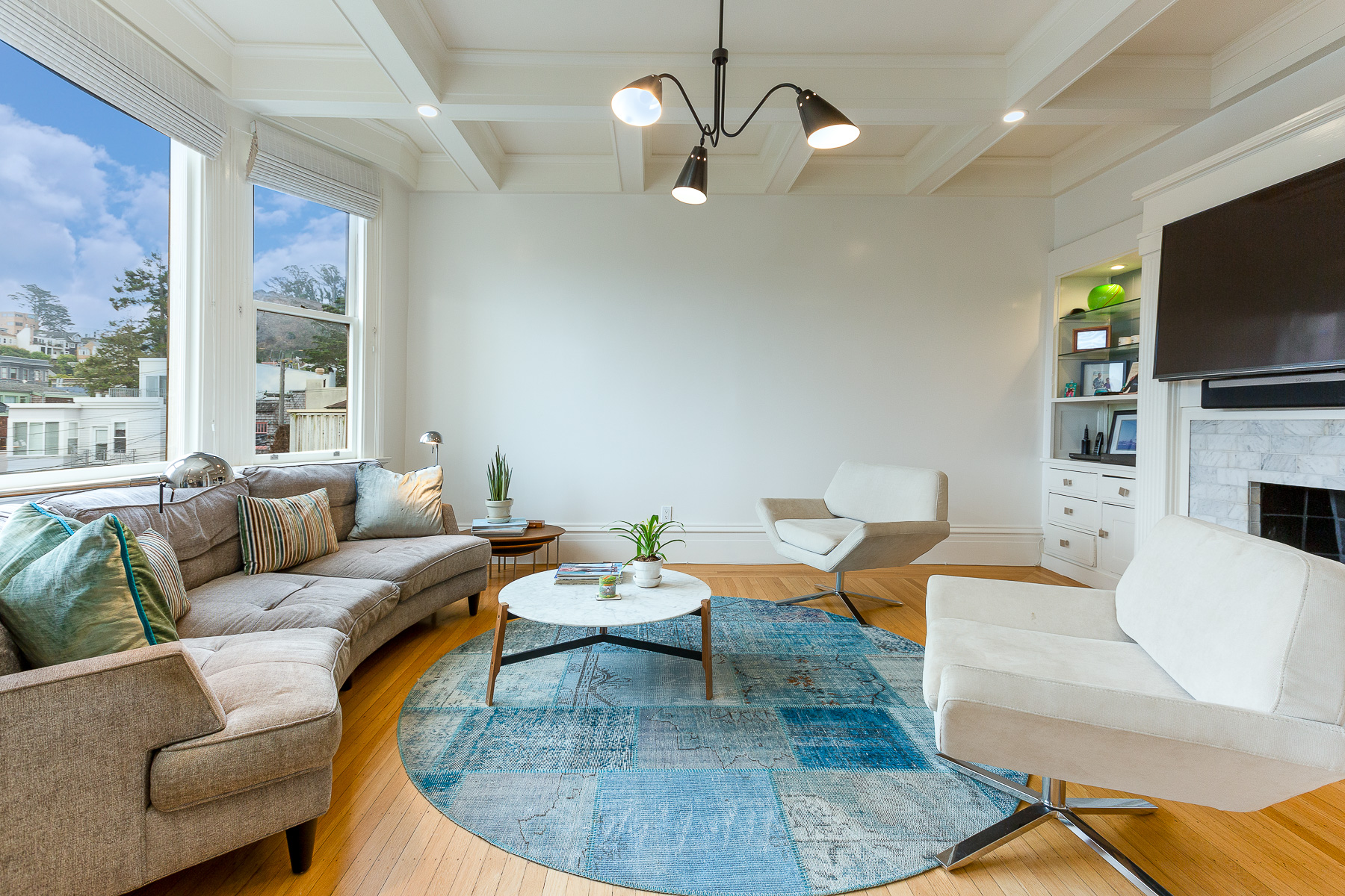Property Photo: Living room featuring wood floors and box beamed ceilings