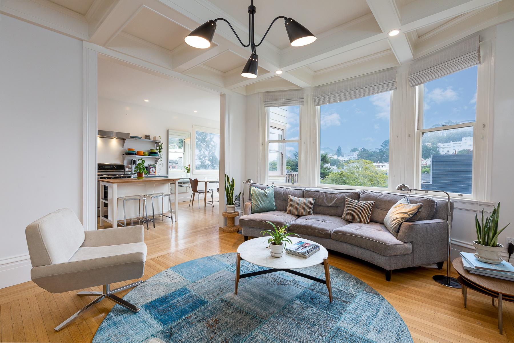 Property Photo: View of the living room, featuring large bay windows and views of Cole Valley