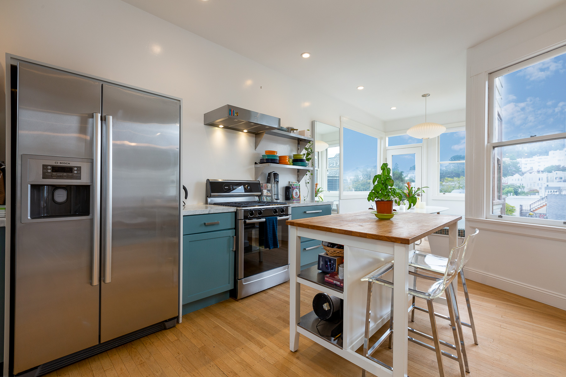 Property Photo: Kitchen featuring wood floors and stainless steel appliances 