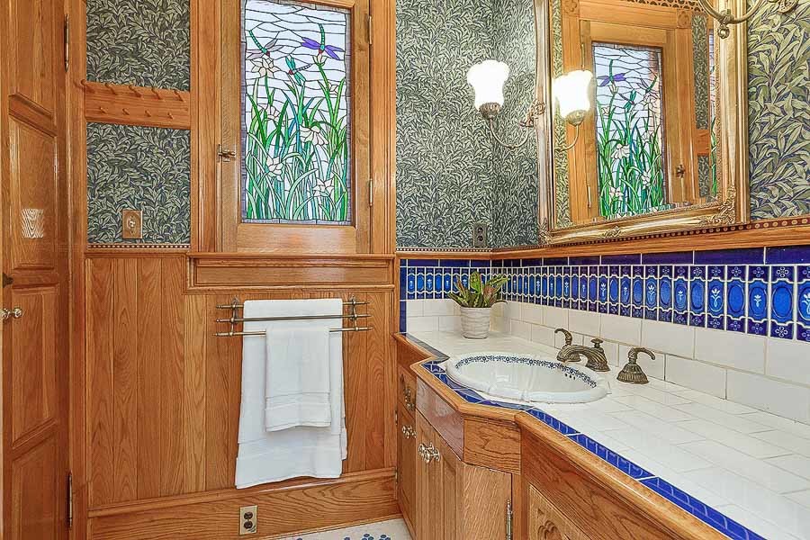 Property Photo: View of a bathroom with lavish woodwork and a sink