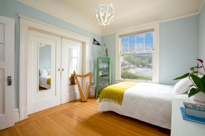 Property Thumbnail: View of bedroom one, showing modern lighting and wood pocket doors
