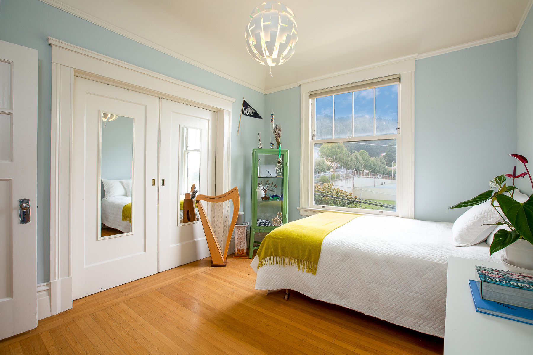 Property Photo: View of bedroom one, showing modern lighting and wood pocket doors