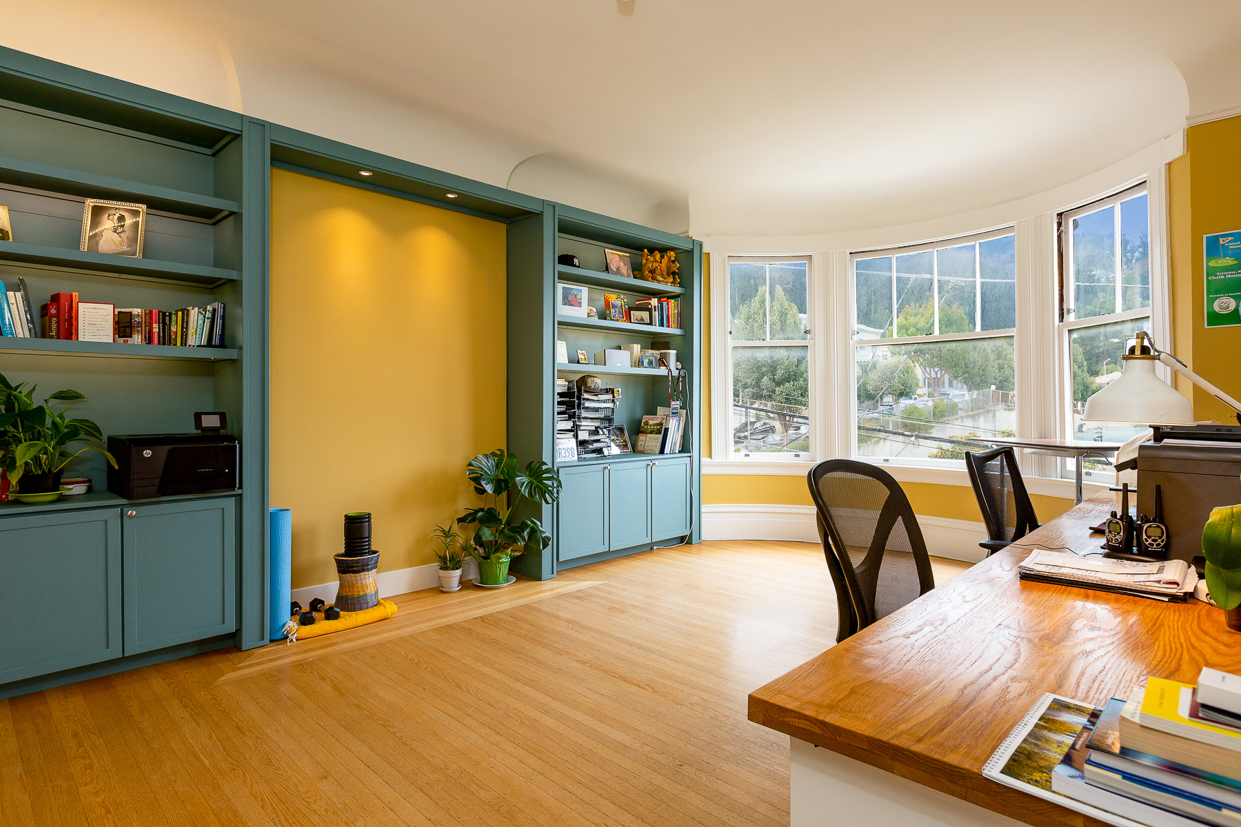 Property Photo: View of the office with built-in cabinets and wood floors