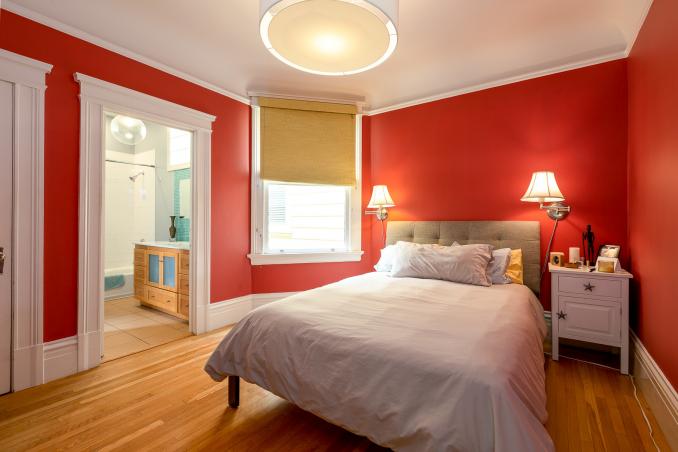 Property Thumbnail: View of bedroom two, showing a large window and adjoining bathroom