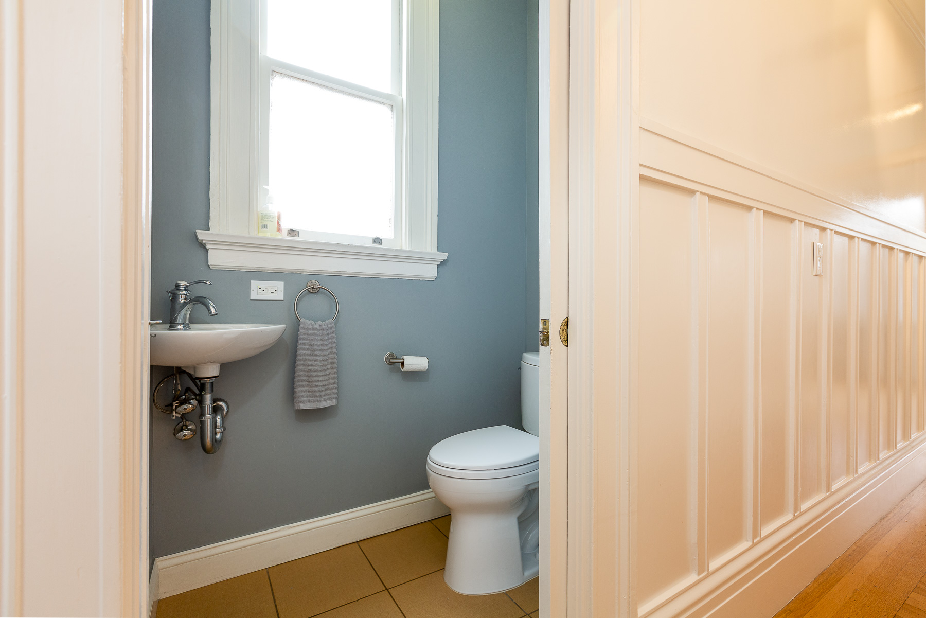 Property Photo: View of a half bath with a sliding pocket door 