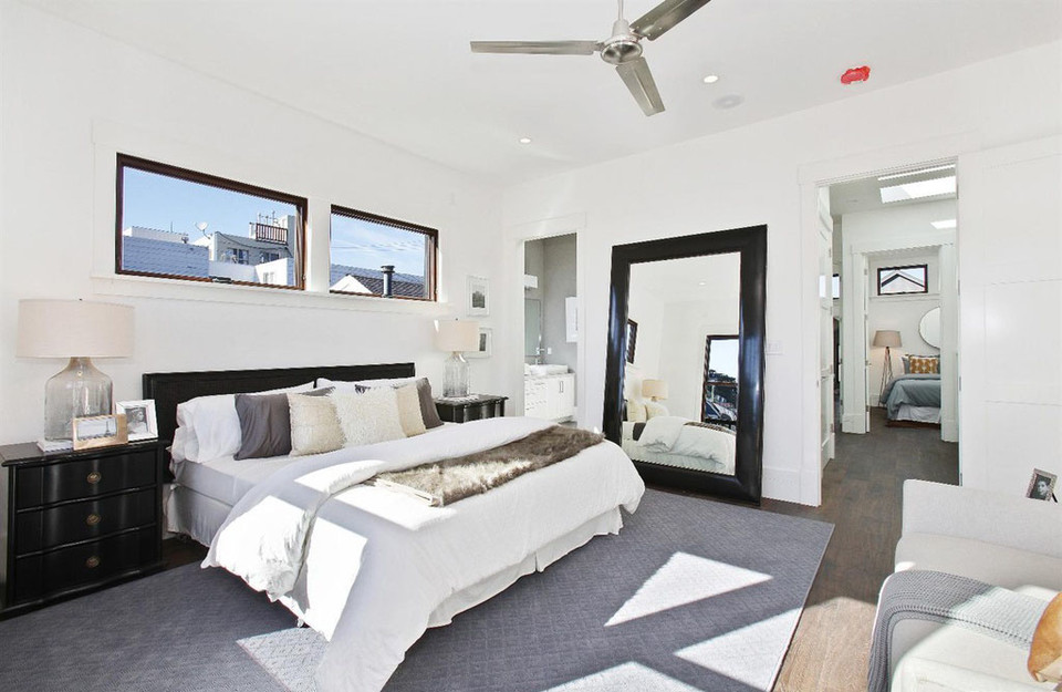 Property Photo: View of a large bedroom, with two long windows