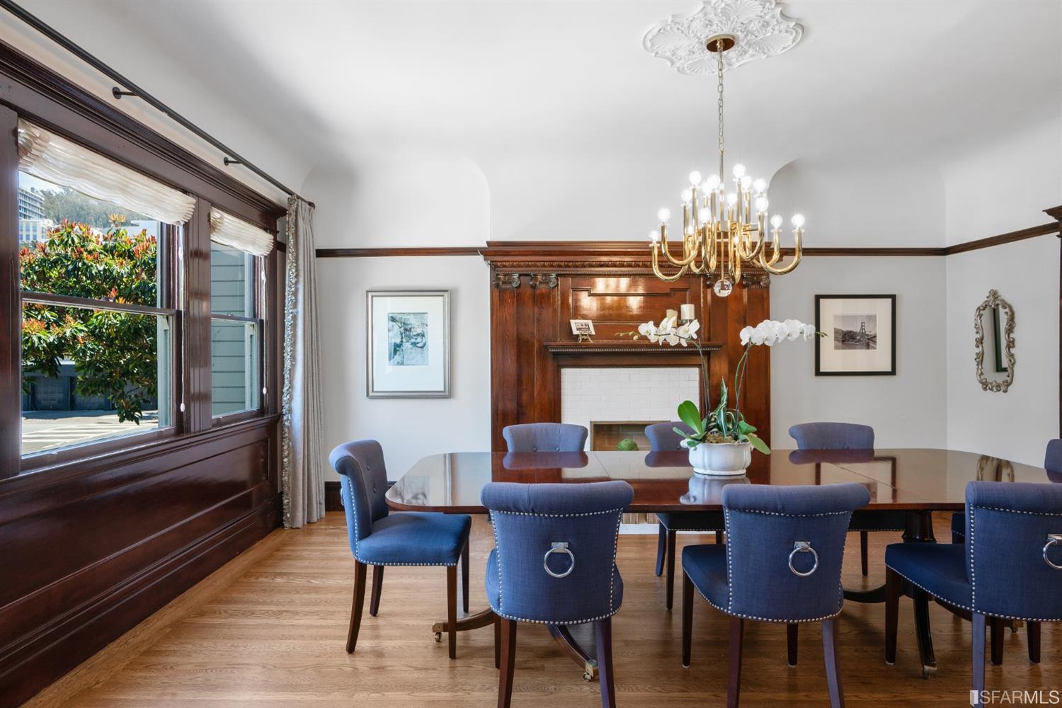 Property Photo: View of the formal dining room, featuring an elegant chandelier and large windows
