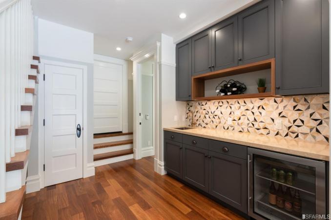 Property Thumbnail: View of the lower kitchen or bar area, featuring a beverage cooler and cabinetry