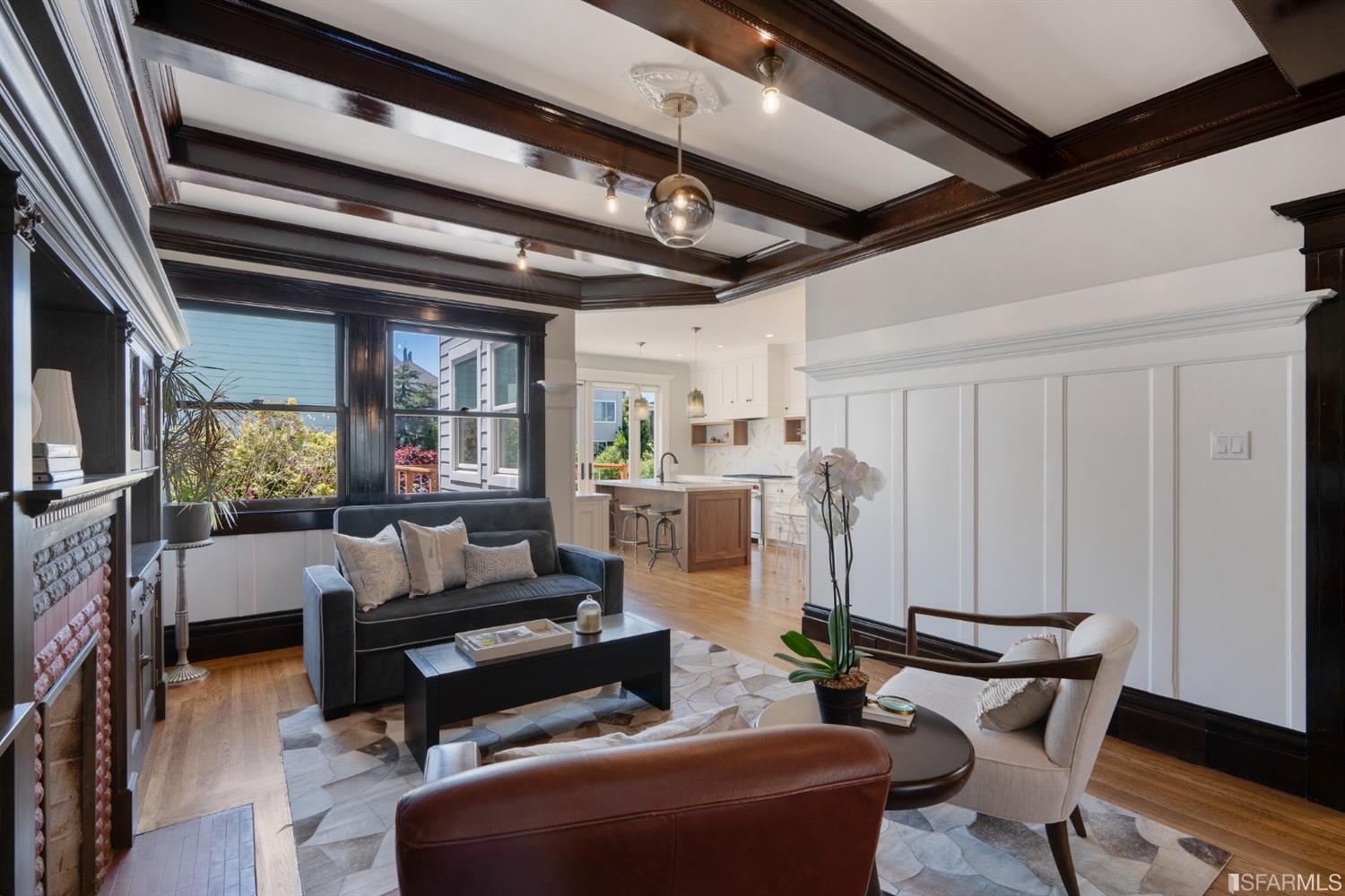Property Photo: Living area featuring wood floors and large windows