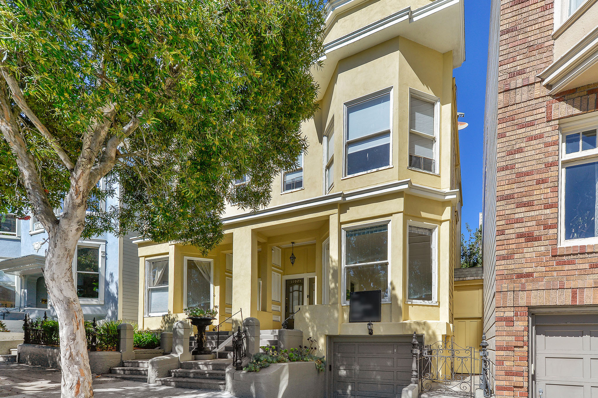 Property Photo: Street view of 1104.5 Fulton Street, showing a yellow home