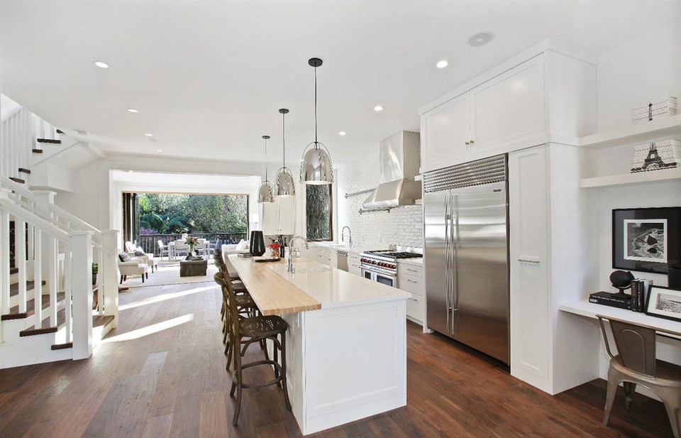 Property Photo: View of a kitchen with wood floors and large open exterior doors