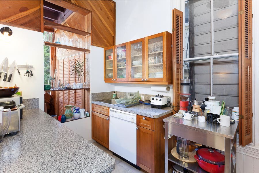 Property Photo: View of the kitchen, showing wood cabinets
