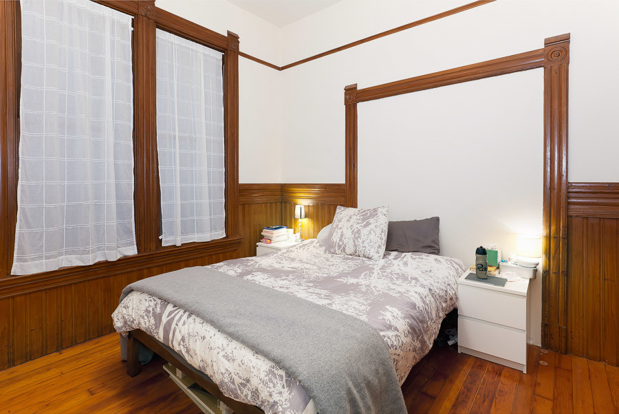 Property Photo: Bedroom with wood floors and windows