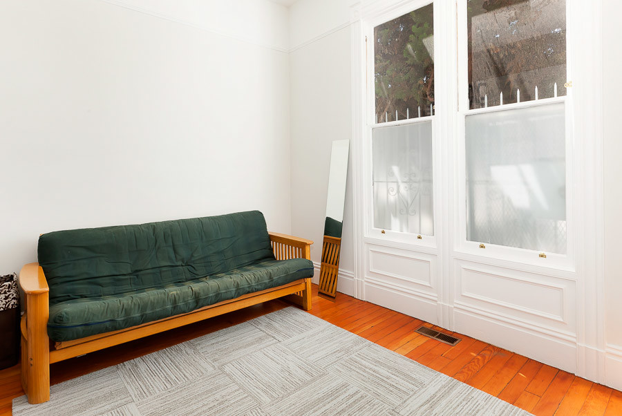 Property Photo: A room with wood floors and large windows