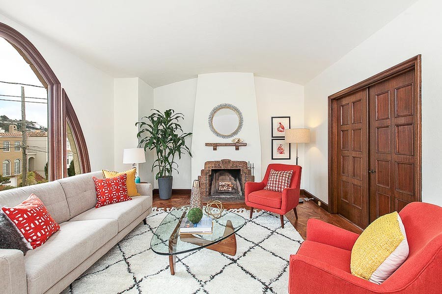 Property Photo: Living room, featuring a fireplace and closed pocket-doors