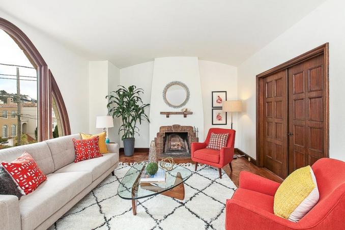 Property Thumbnail: Living room, featuring a fireplace and closed pocket-doors