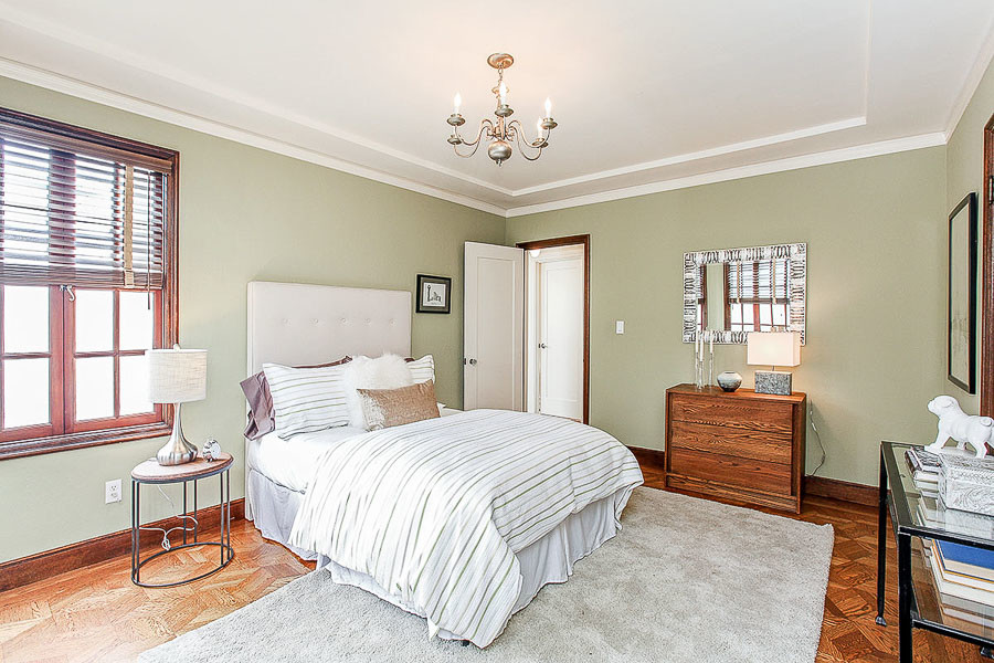 Property Photo: View of a large bedroom with crown moulding and wood floor