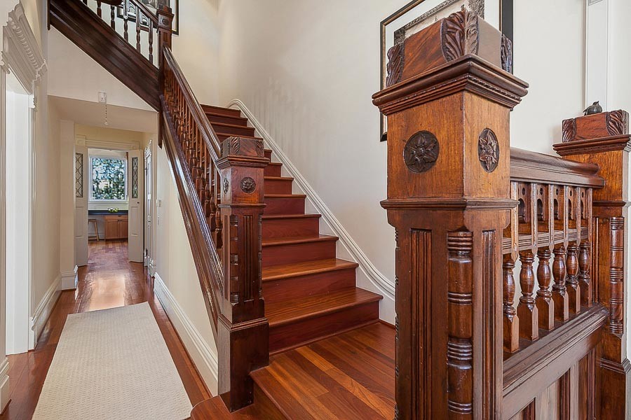 Property Photo: View of wood steps and railing leading upstairs 