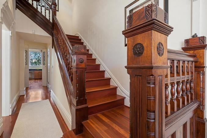 Property Thumbnail: View of wood steps and railing leading upstairs 