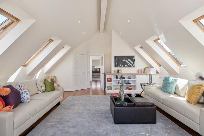 Property Thumbnail: View of a large living area with slanted ceilings and six skylight windows 