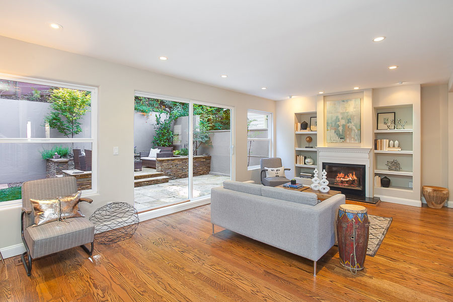 Property Photo: View of the living room, featuring a fireplace and wood floors