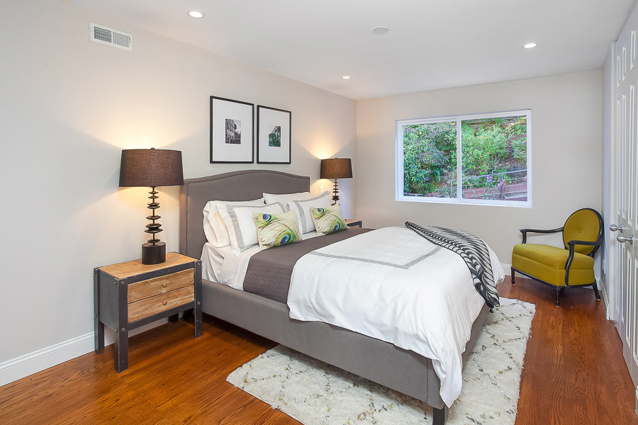 Property Photo: View of a bedroom with wood floors and large window