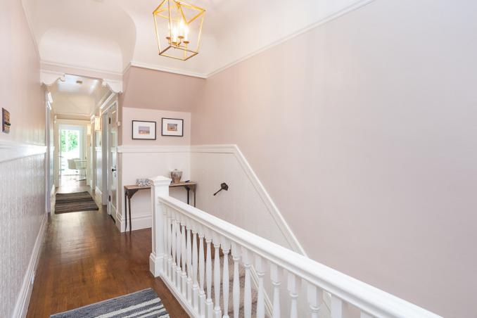 Property Thumbnail: View of the hallway, showing wood floors and white wainscoting