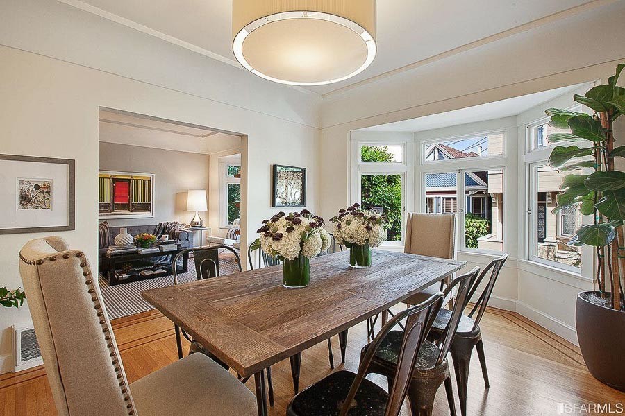 Property Photo: Dining room with wood floors and large windows